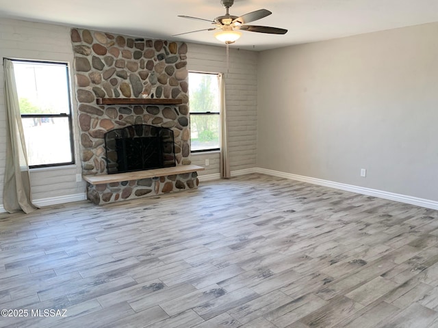 2973 S Kolb Rd, Tucson, AZ 85730 - unfurnished living room featuring wood finished floors, ceiling fan, and a stone fireplace