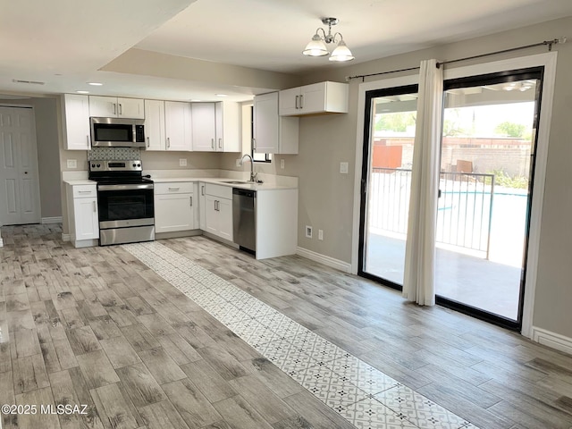2973 S Kolb Rd, Tucson, AZ 85730 - kitchen with stainless steel appliances, light wood-style flooring, white cabinetry, light countertops, and recessed lighting