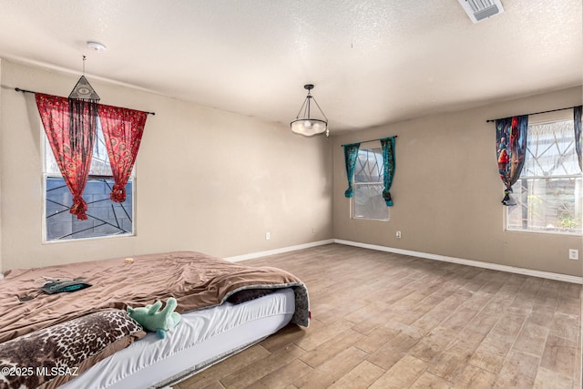 5482 S Monrovia Ave, Tucson, AZ 85706 - bedroom with wood finished floors and a textured ceiling