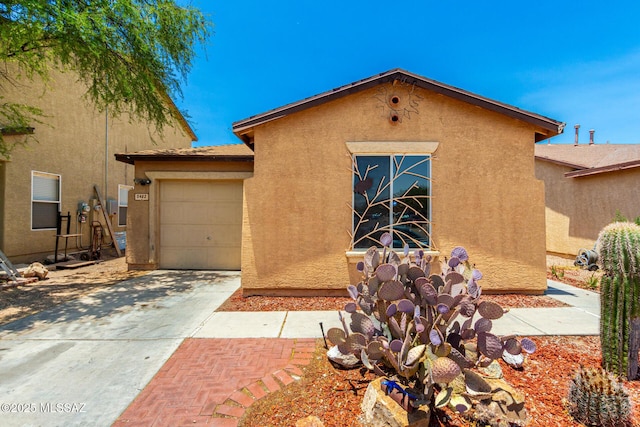 5482 S Monrovia Ave, Tucson, AZ 85706 - view of front facade featuring stucco siding, driveway, and an attached garage