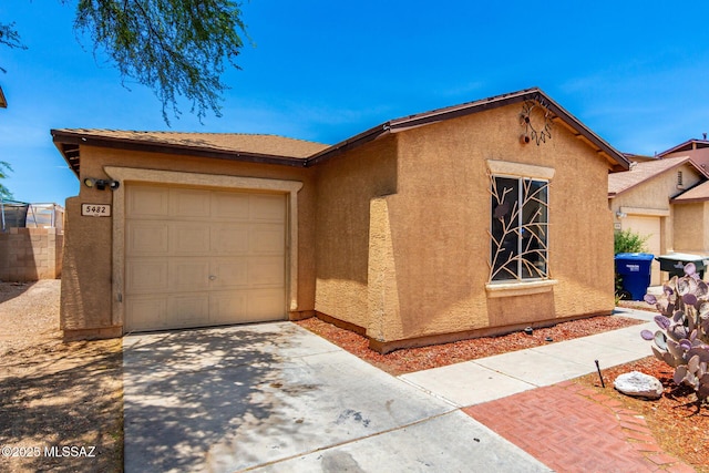 5482 S Monrovia Ave, Tucson, AZ 85706 - view of front of property featuring concrete driveway, stucco siding, and an attached garage