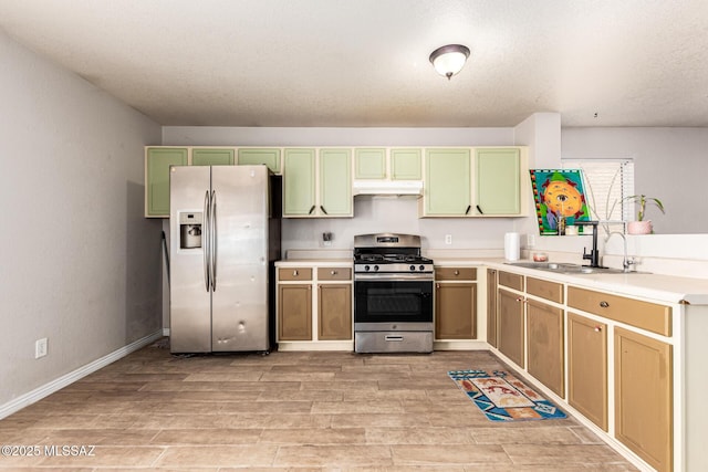 5482 S Monrovia Ave, Tucson, AZ 85706 - kitchen with appliances with stainless steel finishes, under cabinet range hood, light wood finished floors, and green cabinetry