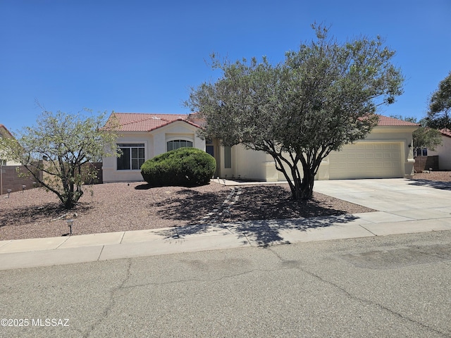 887 Manzanilla Way, Rio Rico, AZ 85648 - view of front facade with a tiled roof, an attached garage, concrete driveway, and stucco siding