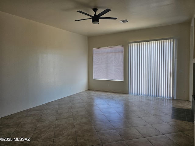 887 Manzanilla Way, Rio Rico, AZ 85648 - empty room featuring a ceiling fan and dark tile patterned flooring