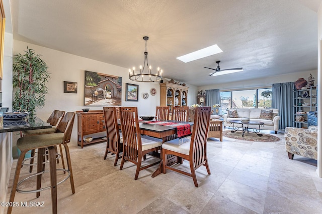 1148 W Circulo Del Norte, Green Valley, AZ 85614 - dining room with a skylight, a chandelier, a textured ceiling, and a ceiling fan