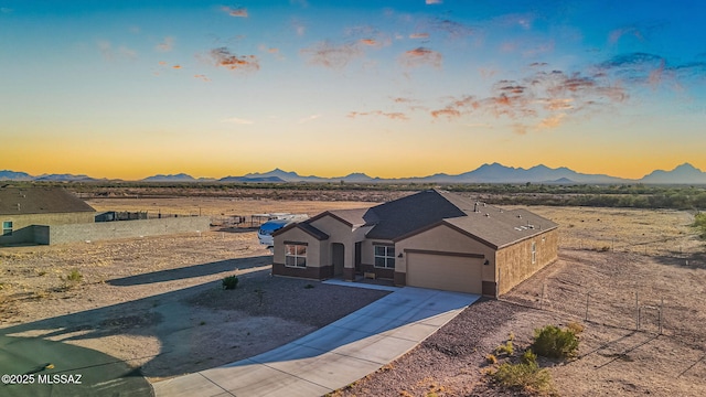 13331 N Carbine Ct, Marana, AZ 85653 - view of front of house with a garage, driveway, a mountain view, and stucco siding