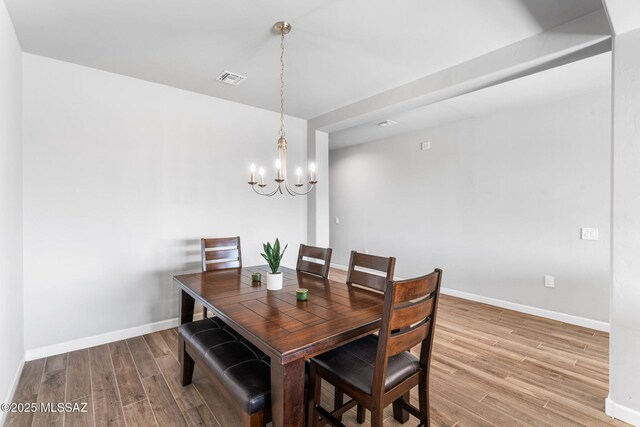 13331 N Carbine Ct, Marana, AZ 85653 - dining area featuring wood finished floors and a chandelier