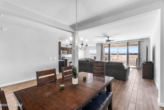 13331 N Carbine Ct, Marana, AZ 85653 - dining area with light wood finished floors, a ceiling fan, and a chandelier
