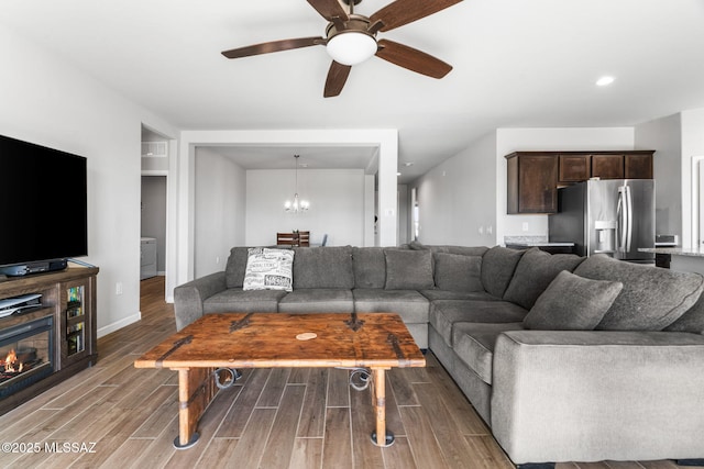 13331 N Carbine Ct, Marana, AZ 85653 - living area featuring wood finished floors, a ceiling fan, and a chandelier