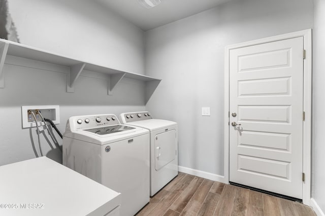 13331 N Carbine Ct, Marana, AZ 85653 - washroom featuring separate washer and dryer and wood finished floors