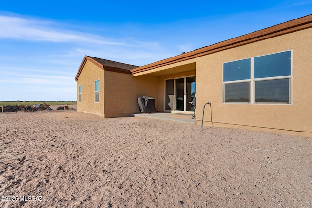 13331 N Carbine Ct, Marana, AZ 85653 - rear view of house with stucco siding and a patio