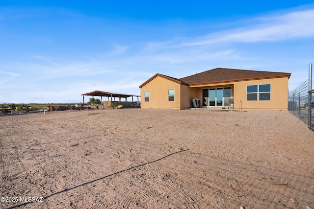 13331 N Carbine Ct, Marana, AZ 85653 - rear view of property featuring stucco siding and a carport