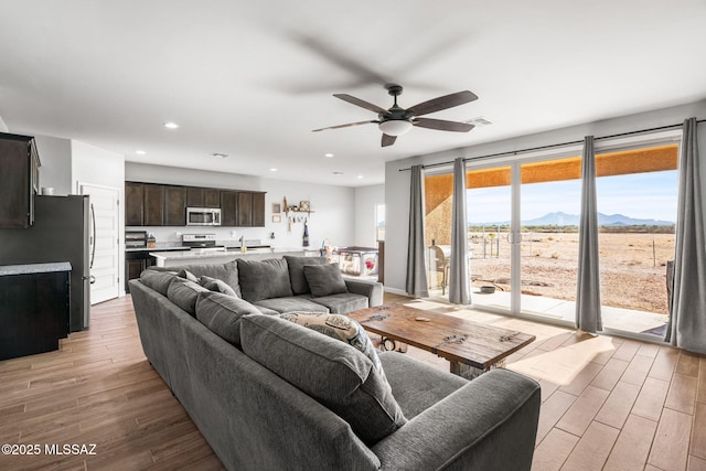 13331 N Carbine Ct, Marana, AZ 85653 - living area with light wood-style flooring, a ceiling fan, recessed lighting, and a mountain view