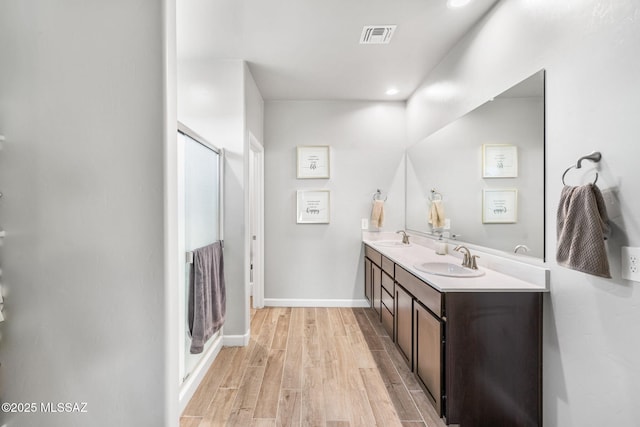 13331 N Carbine Ct, Marana, AZ 85653 - full bathroom featuring double vanity, wood finished floors, a shower stall, and recessed lighting
