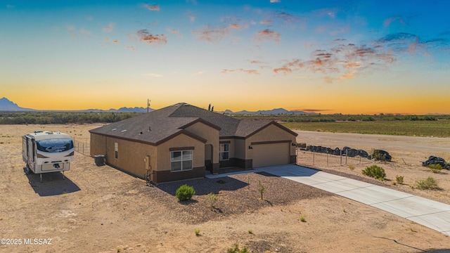 13331 N Carbine Ct, Marana, AZ 85653 - ranch-style home featuring a mountain view, concrete driveway, an attached garage, and stucco siding