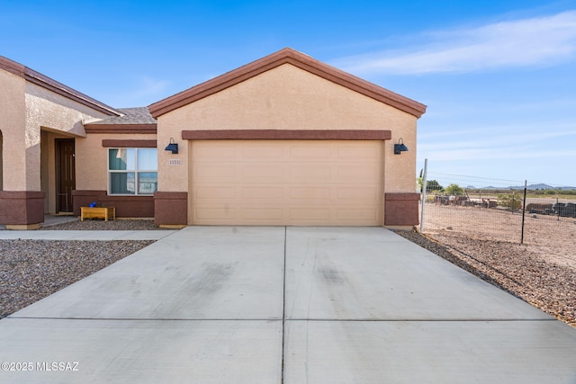 13331 N Carbine Ct, Marana, AZ 85653 - view of front of house with stucco siding, concrete driveway, and a garage