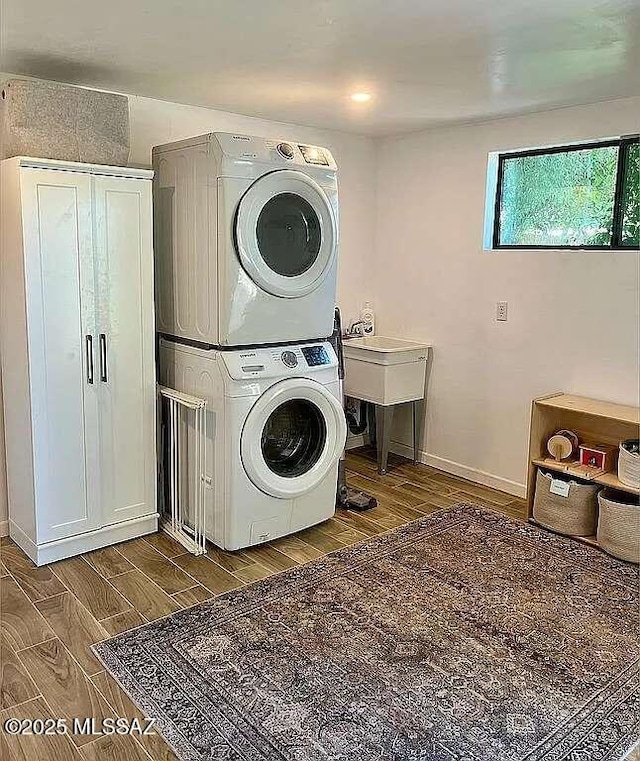2602 E Prince Rd, Tucson, AZ 85716 - laundry area with stacked washer / drying machine and wood finished floors