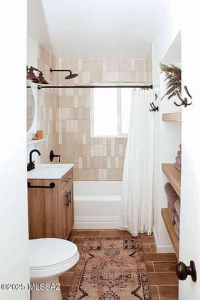 2602 E Prince Rd, Tucson, AZ 85716 - bathroom featuring vanity, shower / bathtub combination with curtain, and wood finished floors