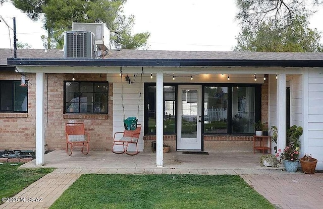 2602 E Prince Rd, Tucson, AZ 85716 - view of exterior entry featuring a shingled roof and brick siding