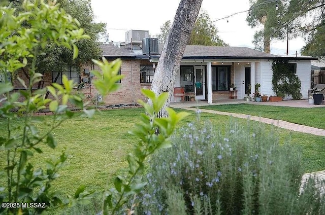 2602 E Prince Rd, Tucson, AZ 85716 - back of property featuring a lawn and a patio area