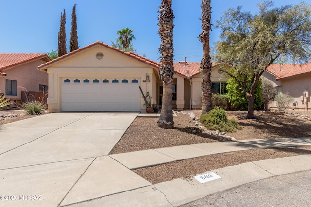 8410 E Heath Ct, Tucson, AZ 85715 - view of front of property featuring stucco siding, a tile roof, driveway, and an attached garage
