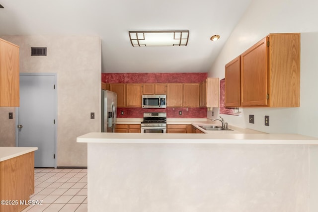 8410 E Heath Ct, Tucson, AZ 85715 - kitchen featuring appliances with stainless steel finishes, light countertops, a peninsula, and light tile patterned flooring
