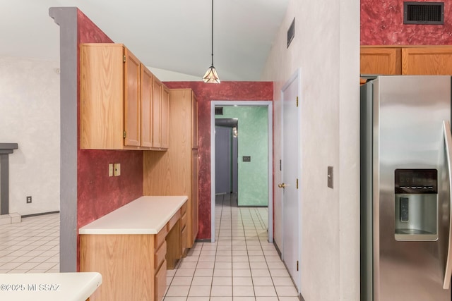 8410 E Heath Ct, Tucson, AZ 85715 - kitchen featuring stainless steel refrigerator with ice dispenser, light tile patterned floors, light countertops, and hanging light fixtures