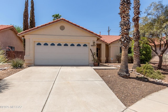 8410 E Heath Ct, Tucson, AZ 85715 - view of front of property featuring a tile roof, driveway, stucco siding, and an attached garage