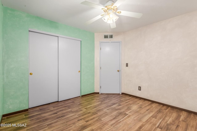 8410 E Heath Ct, Tucson, AZ 85715 - unfurnished bedroom featuring wood finished floors, ceiling fan, and a closet