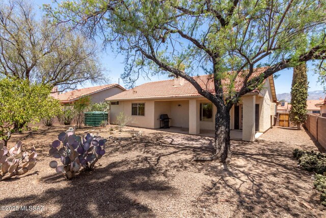 8410 E Heath Ct, Tucson, AZ 85715 - back of house featuring a tiled roof, stucco siding, and a patio area