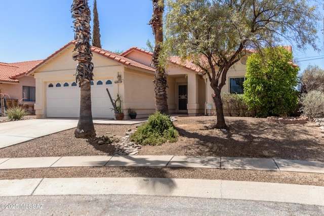 8410 E Heath Ct, Tucson, AZ 85715 - view of front facade with concrete driveway, a garage, stucco siding, and a tile roof