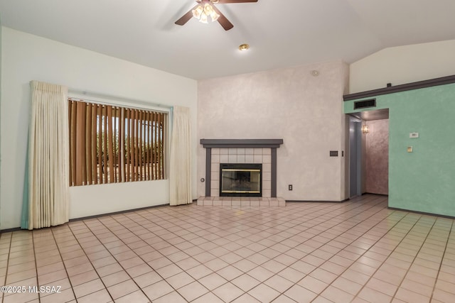 8410 E Heath Ct, Tucson, AZ 85715 - unfurnished living room featuring a ceiling fan, lofted ceiling, a tiled fireplace, and tile patterned flooring