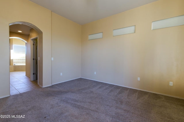 17160 W Starr Rd, Marana, AZ 85653 - carpeted spare room featuring arched walkways and tile patterned flooring