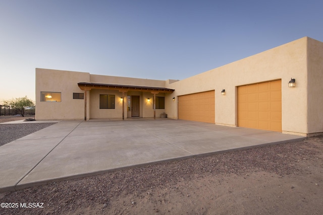 17160 W Starr Rd, Marana, AZ 85653 - pueblo-style home featuring stucco siding, a garage, and concrete driveway