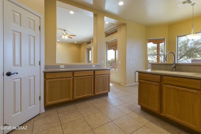 17160 W Starr Rd, Marana, AZ 85653 - kitchen featuring light tile patterned floors, brown cabinets, pendant lighting, ceiling fan, and recessed lighting