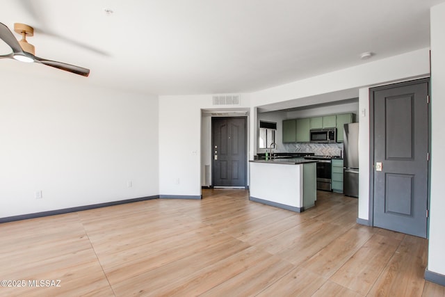 5751 N Kolb Rd Unit 39202, Tucson, AZ 85750 - kitchen with appliances with stainless steel finishes, green cabinetry, dark countertops, ceiling fan, and tasteful backsplash