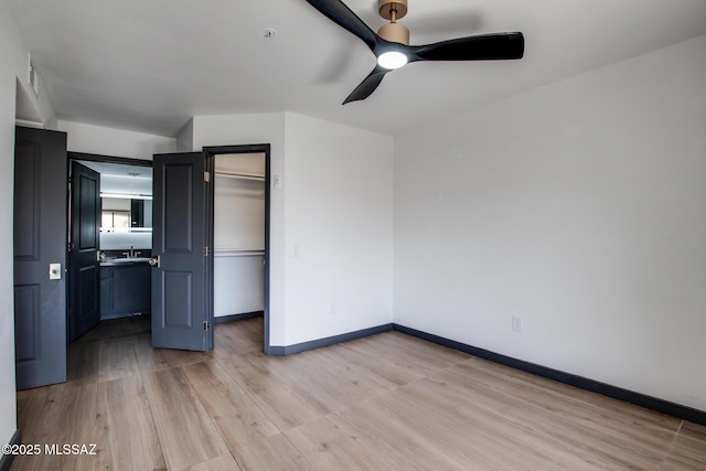 5751 N Kolb Rd Unit 39202, Tucson, AZ 85750 - unfurnished bedroom with light wood finished floors, a closet, a ceiling fan, and a walk in closet