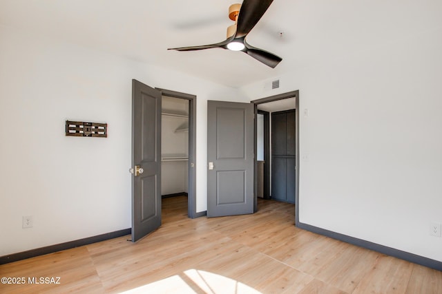 5751 N Kolb Rd Unit 39202, Tucson, AZ 85750 - unfurnished bedroom with light wood finished floors, ceiling fan, a walk in closet, and a closet