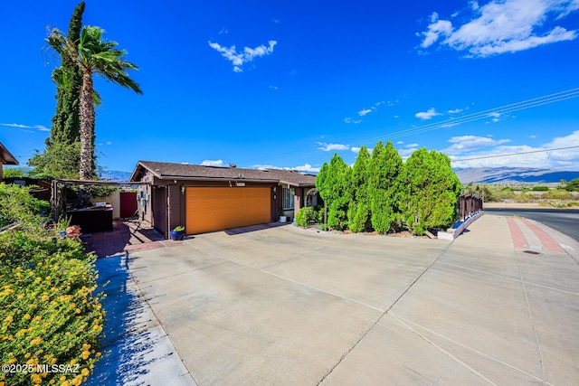 8681 E Desert Palm St, Tucson, AZ 85730 - view of front facade with an attached garage, roof mounted solar panels, concrete driveway, and a carport