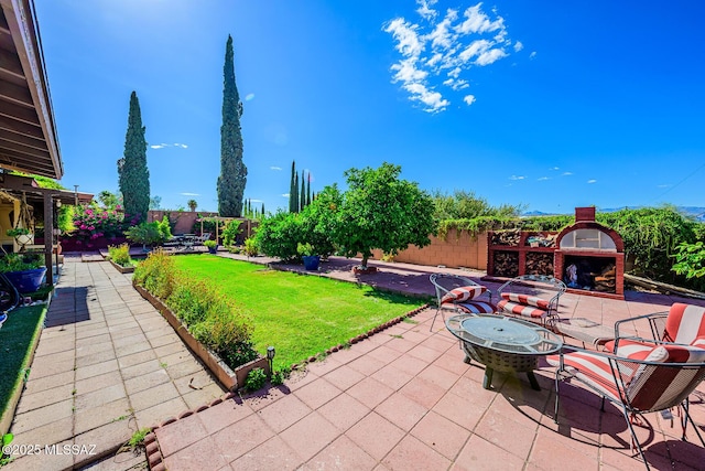 8681 E Desert Palm St, Tucson, AZ 85730 - view of patio / terrace with exterior fireplace
