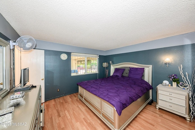 8681 E Desert Palm St, Tucson, AZ 85730 - bedroom with light wood finished floors and a textured ceiling