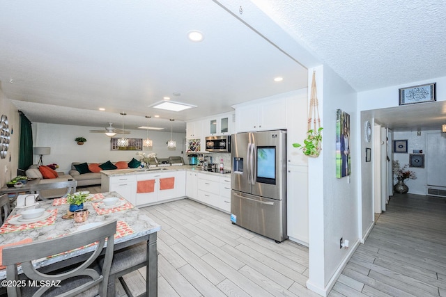 8681 E Desert Palm St, Tucson, AZ 85730 - kitchen with appliances with stainless steel finishes, open floor plan, a peninsula, glass insert cabinets, and white cabinets