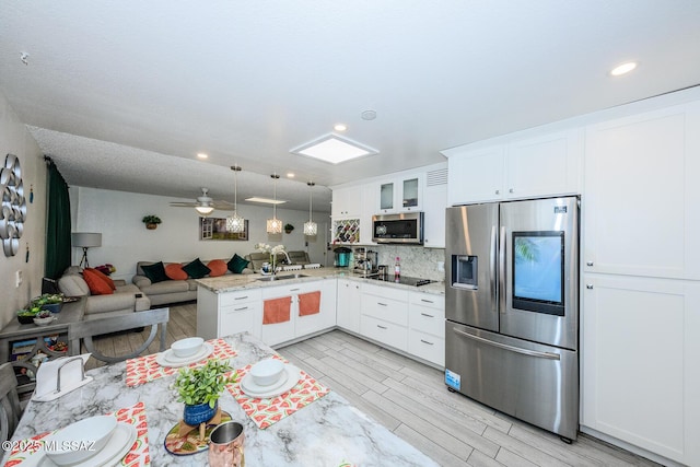 8681 E Desert Palm St, Tucson, AZ 85730 - kitchen featuring appliances with stainless steel finishes, open floor plan, a peninsula, glass insert cabinets, and white cabinetry