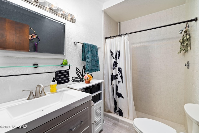 53 N Davila Cir, Tucson, AZ 85745 - full bathroom featuring vanity, a shower stall, and wood finished floors