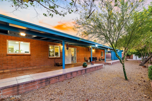 53 N Davila Cir, Tucson, AZ 85745 - back of property at dusk with a patio