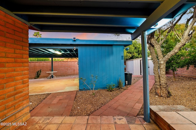 53 N Davila Cir, Tucson, AZ 85745 - fenced backyard featuring a storage shed and a patio area