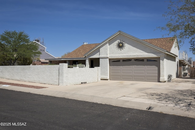 2856 W Goldfield Dr, Tucson, AZ 85745 - ranch-style house featuring an attached garage, driveway, and stucco siding