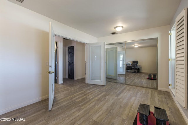 2856 W Goldfield Dr, Tucson, AZ 85745 - unfurnished bedroom featuring a desk, wood finished floors, and a closet