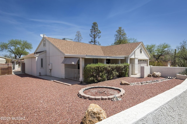 2856 W Goldfield Dr, Tucson, AZ 85745 - single story home featuring an attached garage, a shingled roof, and a gate