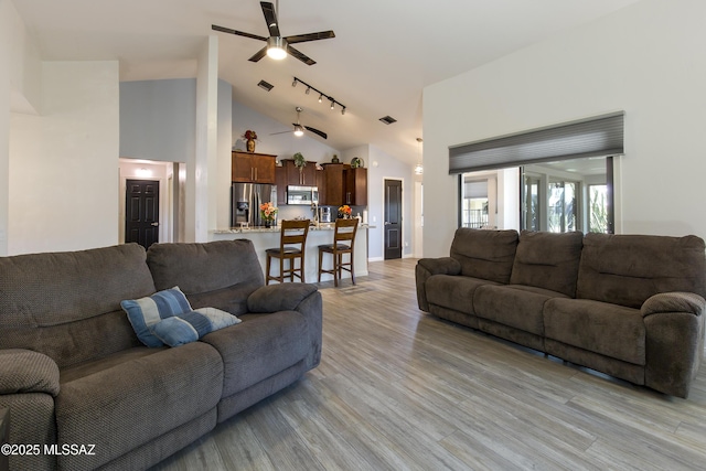 2856 W Goldfield Dr, Tucson, AZ 85745 - living room with ceiling fan, light wood-type flooring, high vaulted ceiling, and rail lighting